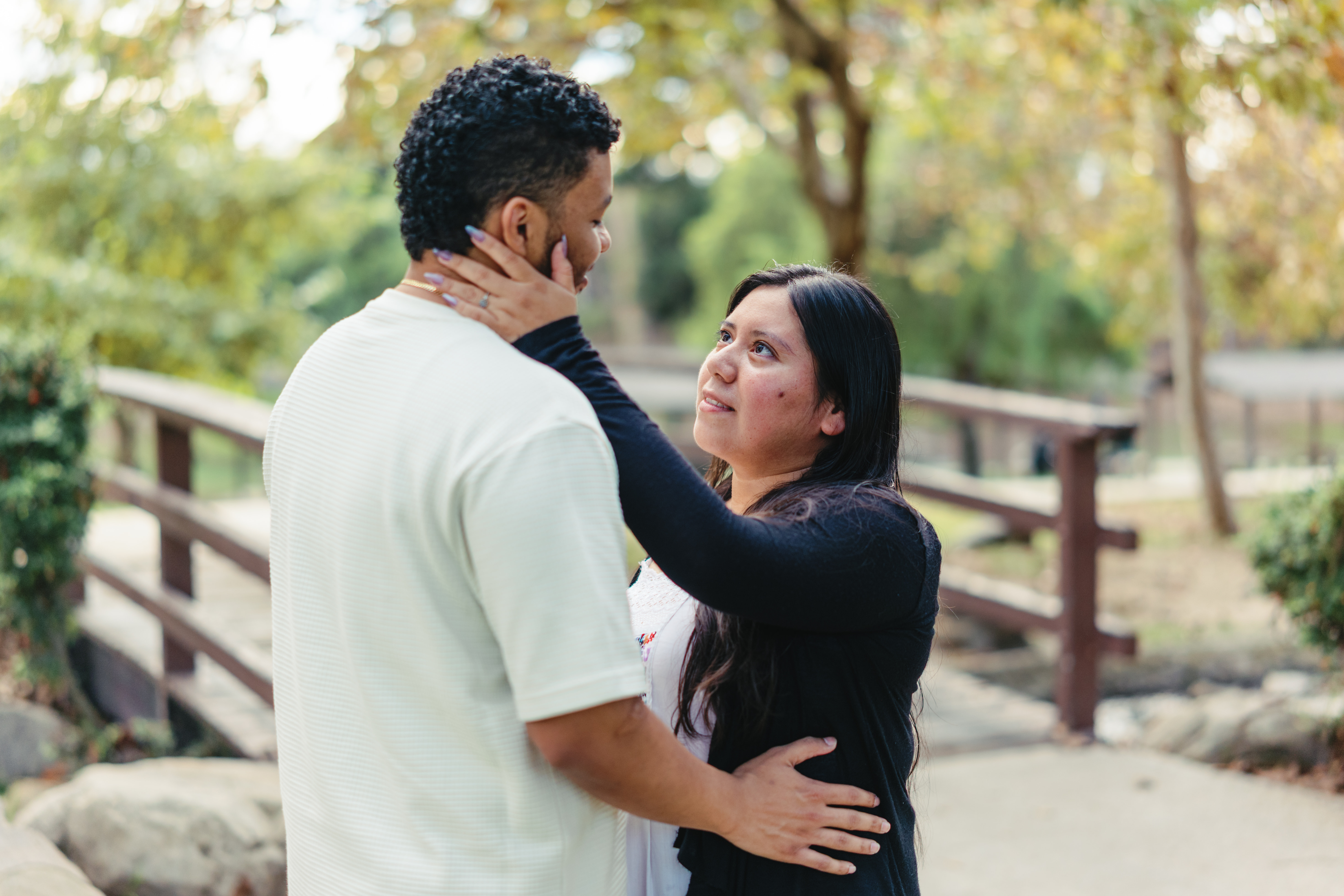 Couple embracing among sunlit greenery