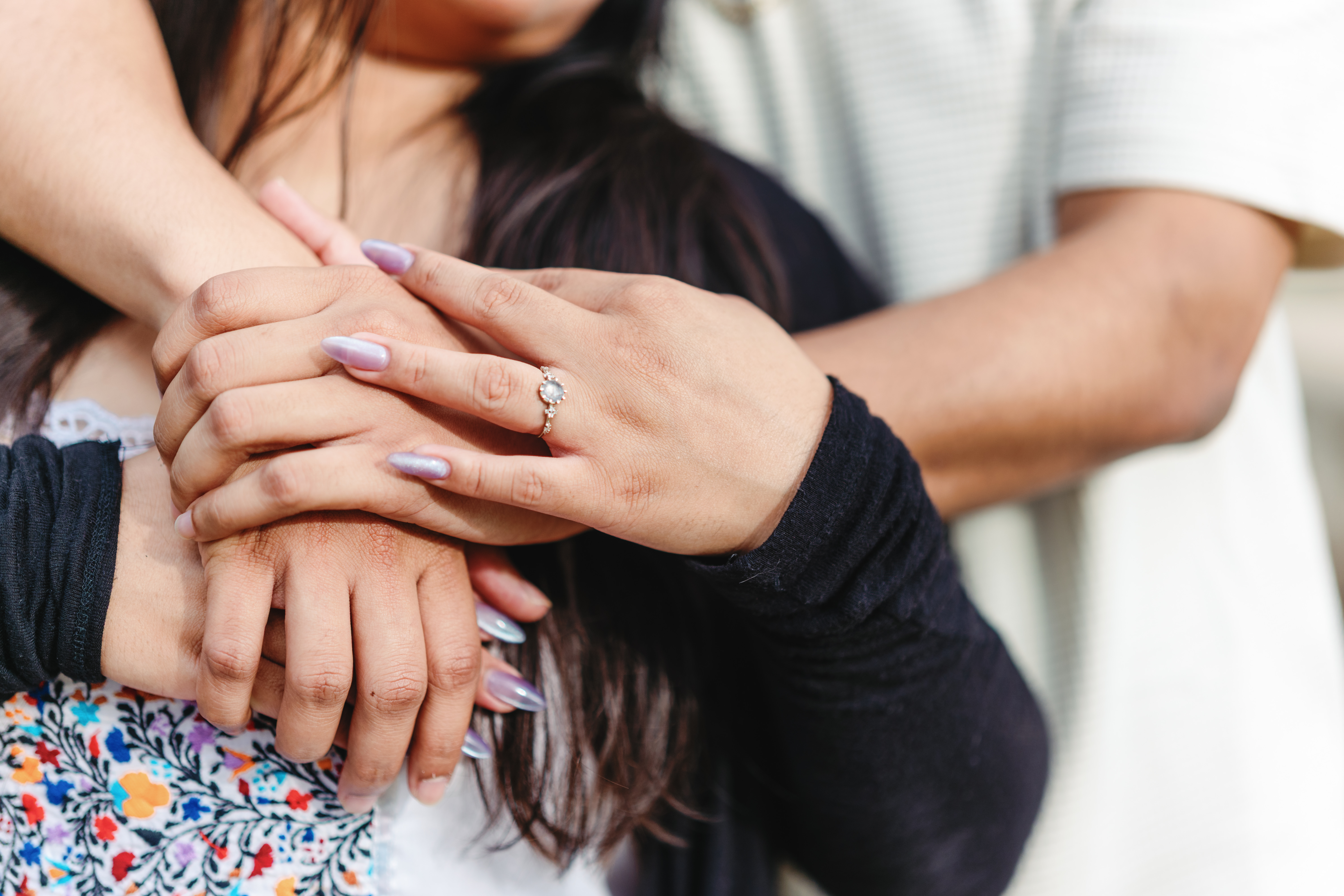 Close-up of the couple's hands and engagement ring