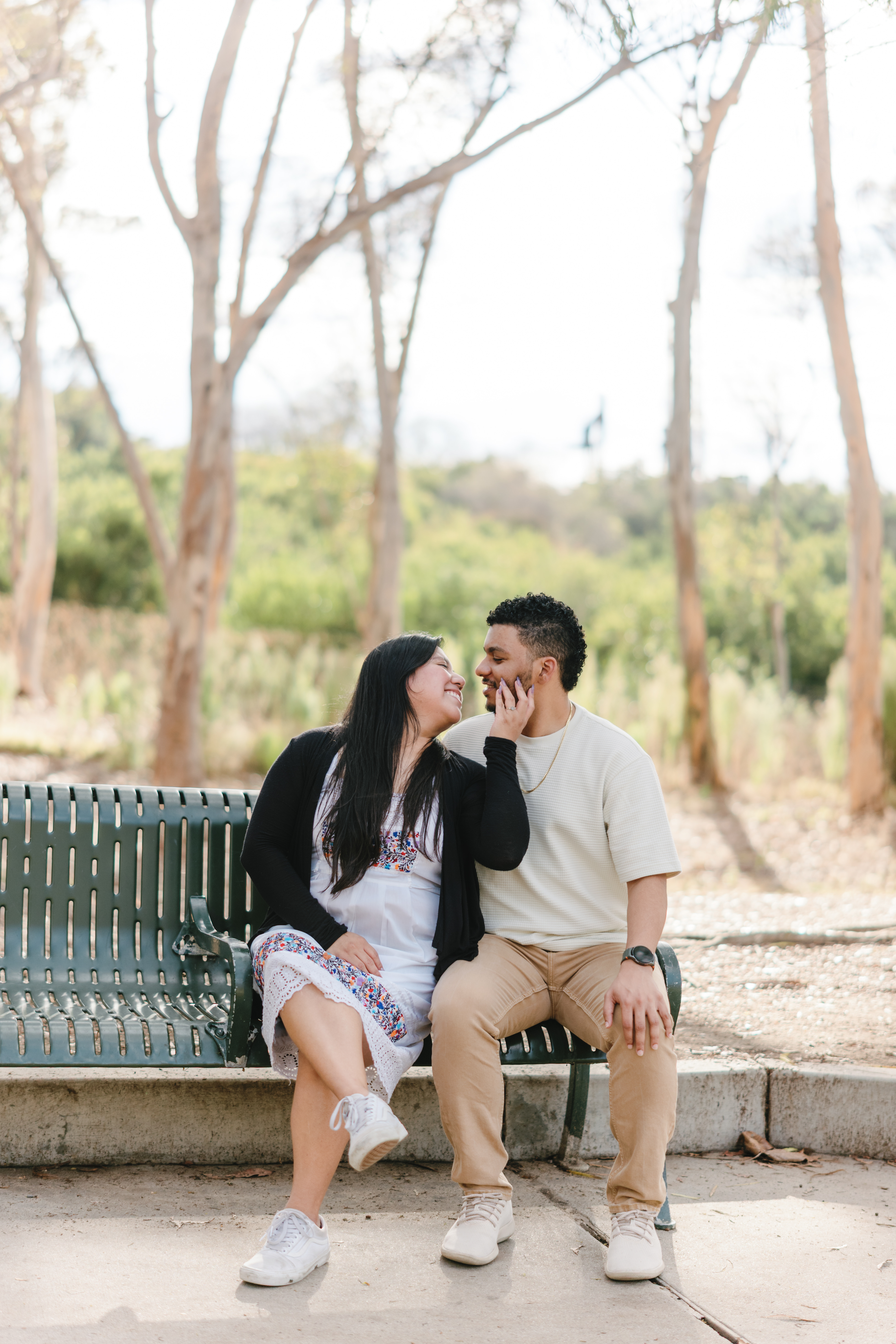 Couple seated together on a park bench
