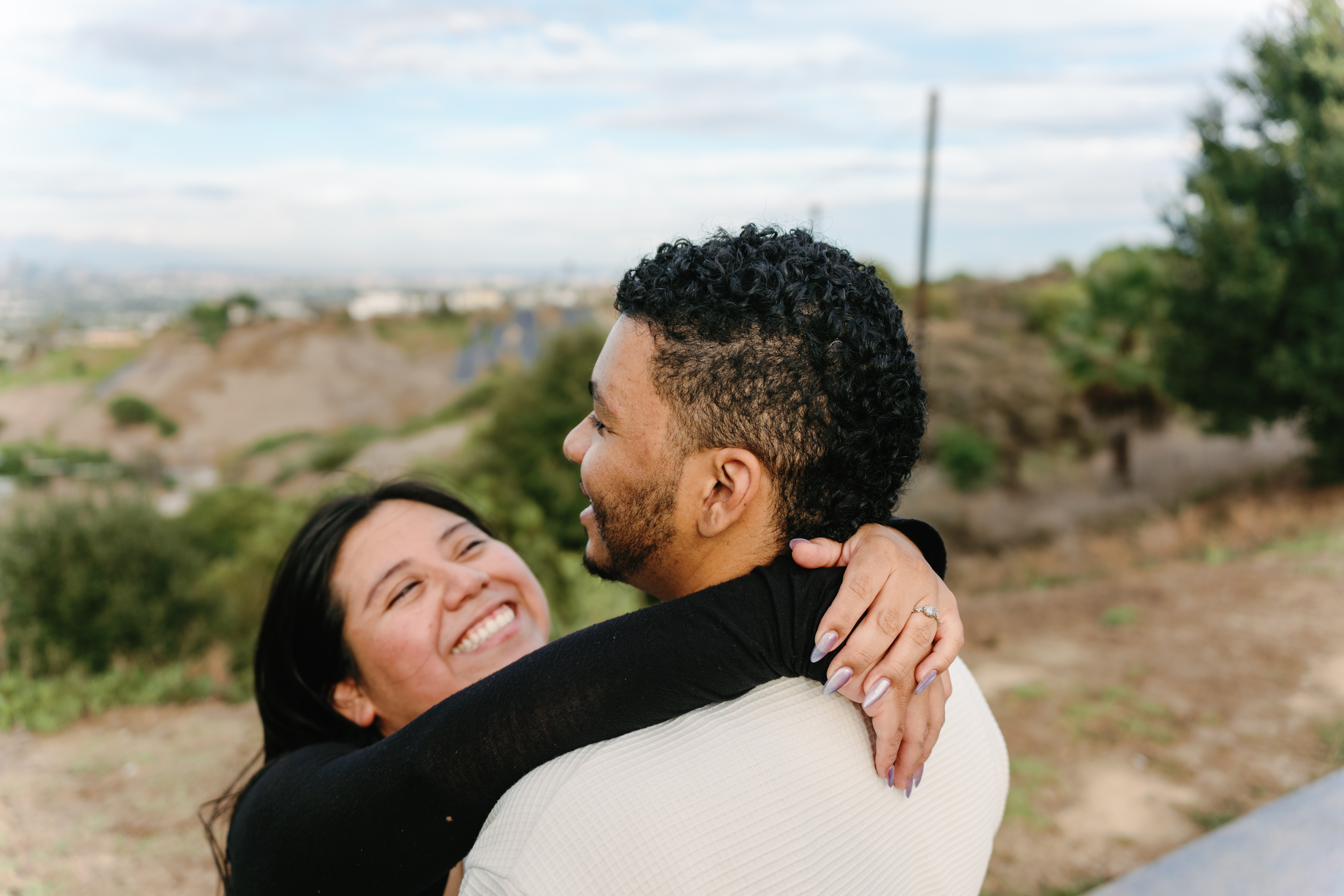 Couple smiling together through a park railing